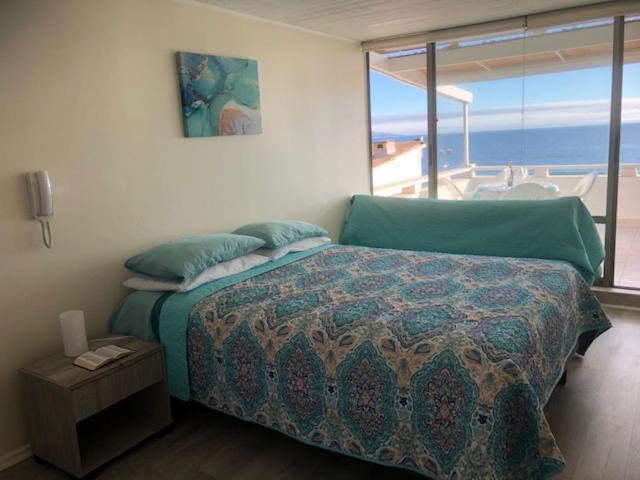 Schlafzimmer mit einem Bett und Meerblick in der Unterkunft Sunset view in Viña del Mar