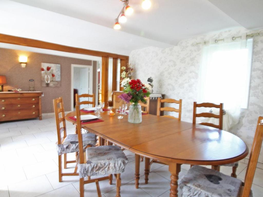 a dining room with a wooden table and chairs at Gîte Champosoult, 5 pièces, 6 personnes - FR-1-497-27 in Champosoult