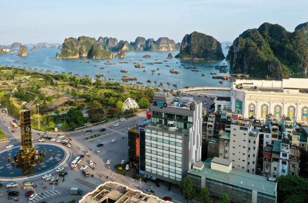 a view of a city with a river and buildings at SOJO Hotel Ha Long in Ha Long