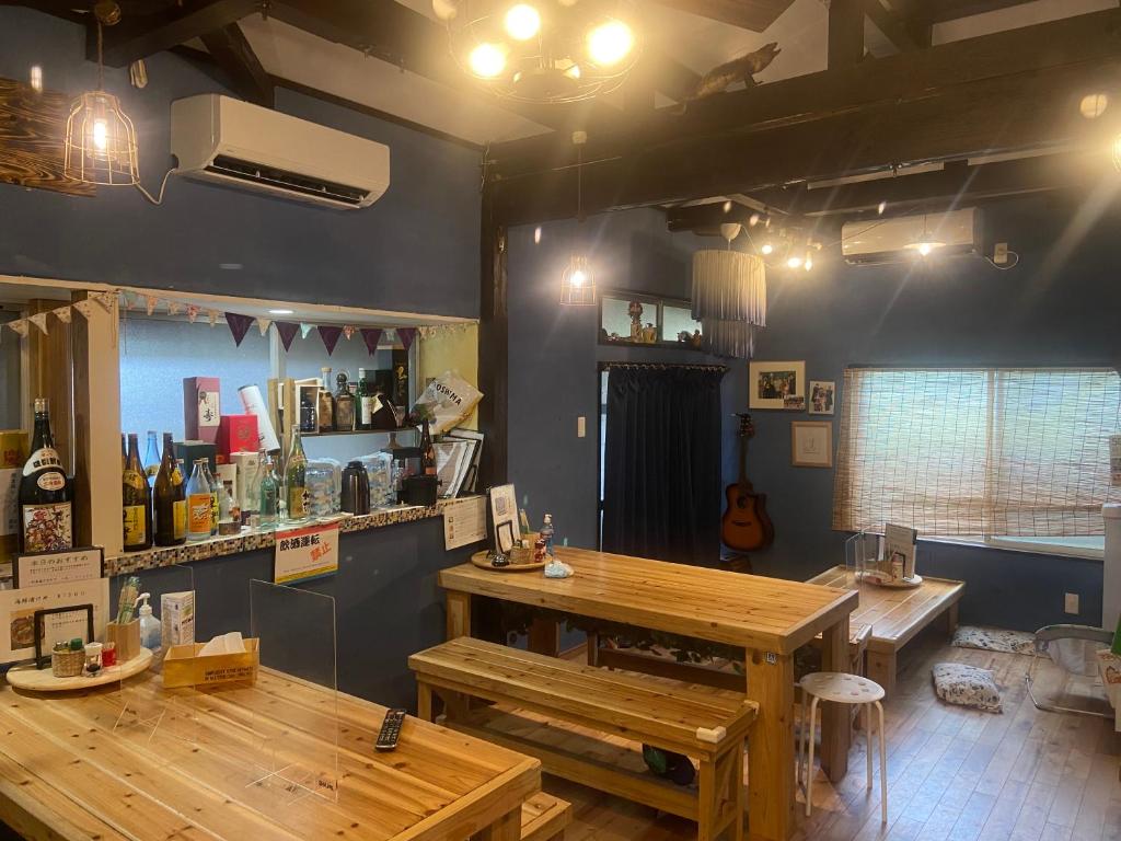 a room with a table and benches in a store at Holiday Cottage BANSHIRO in Setouchi