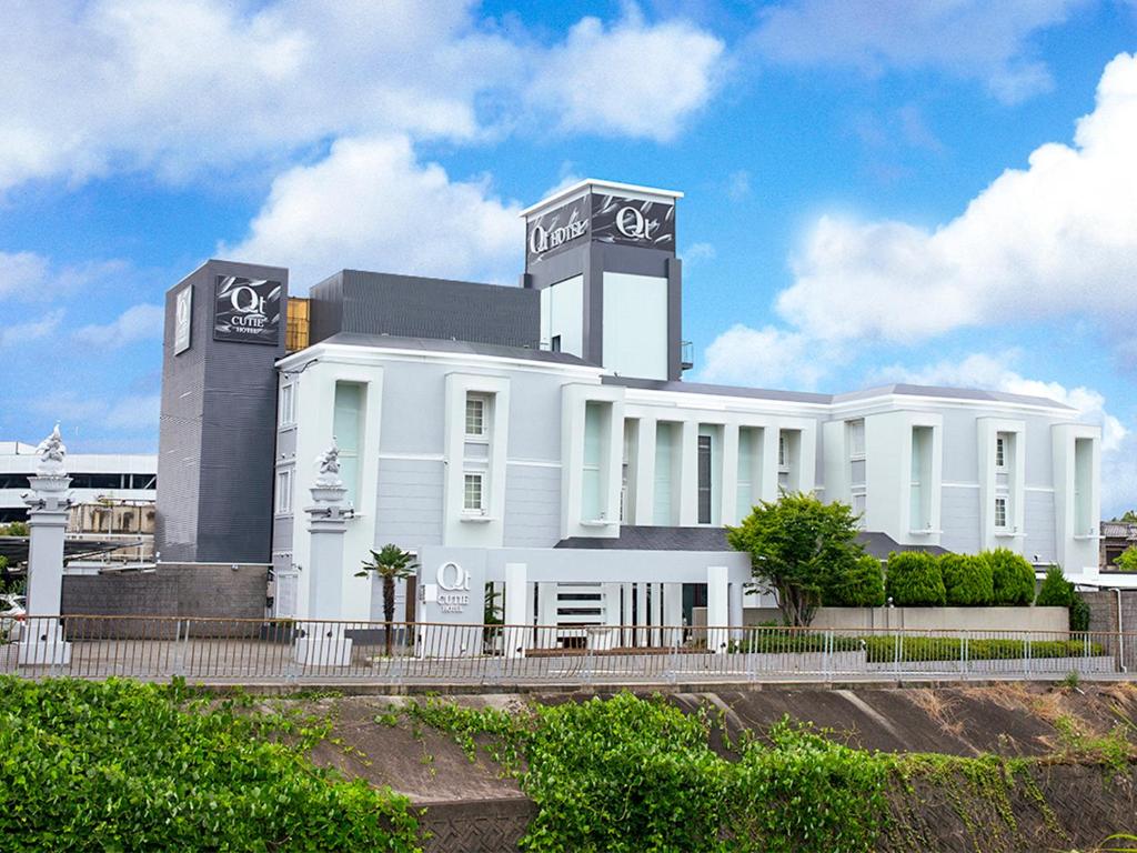 a white building with a sign on top of it at Hotel QT Senboku (Adult Only) in Sakai
