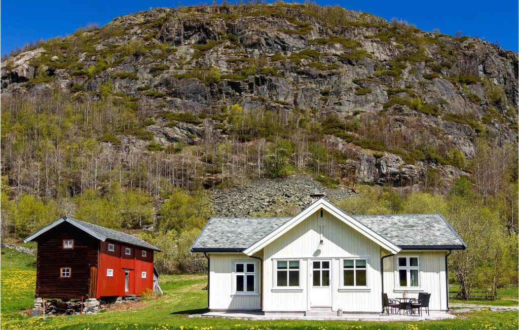 a house and a barn in front of a mountain at Nice Home In Hemsedal With Sauna in Hemsedal