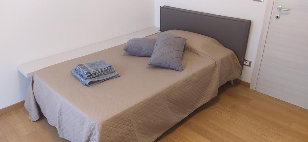a bed with two pillows on it in a room at B&B Markone Bologna Center in Bologna