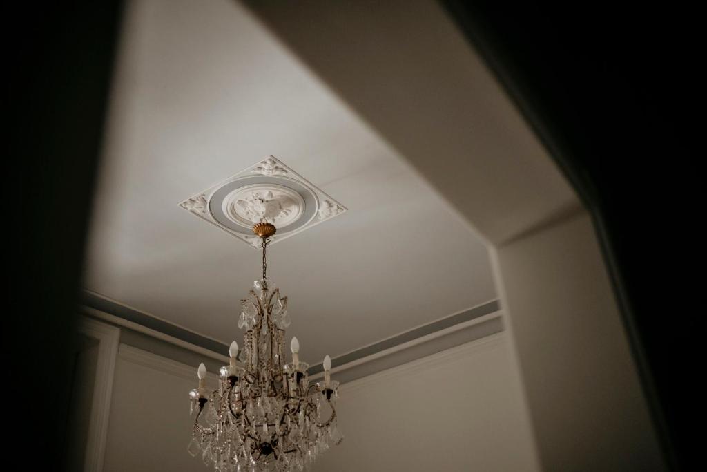 a chandelier hanging from a ceiling in a room at Lex Suites in Catania