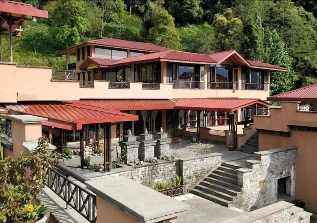 an image of a house with red roofs at The Chumbi Mountain Retreat & Spa in Pelling