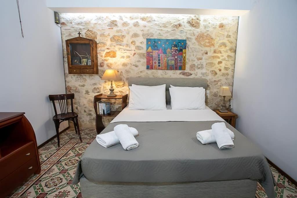 a bedroom with a bed with two towels on it at Malama's maisonette at the historic center in Heraklio Town