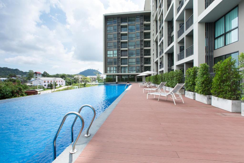 a swimming pool on the side of a building at Sugar Palm Residence in Phuket Town