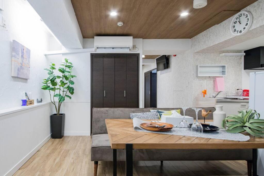 a kitchen and dining room with a wooden table at THE HARMONY in Sapporo