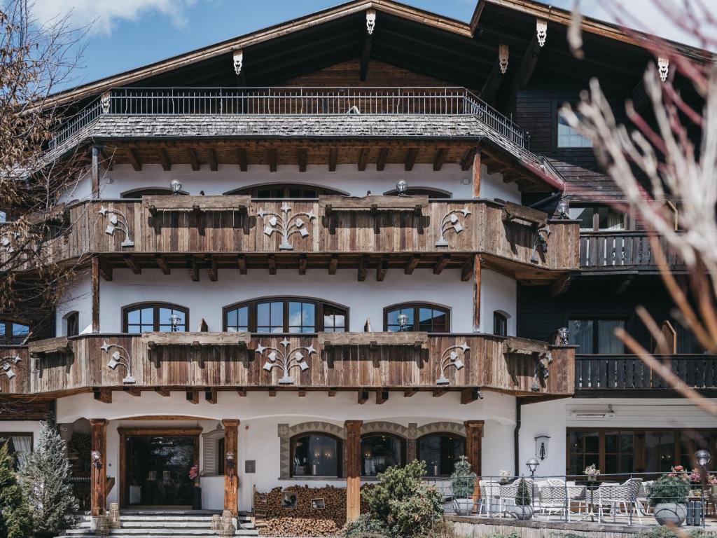 a large wooden house with a balcony at VAYA Seefeld in Seefeld in Tirol