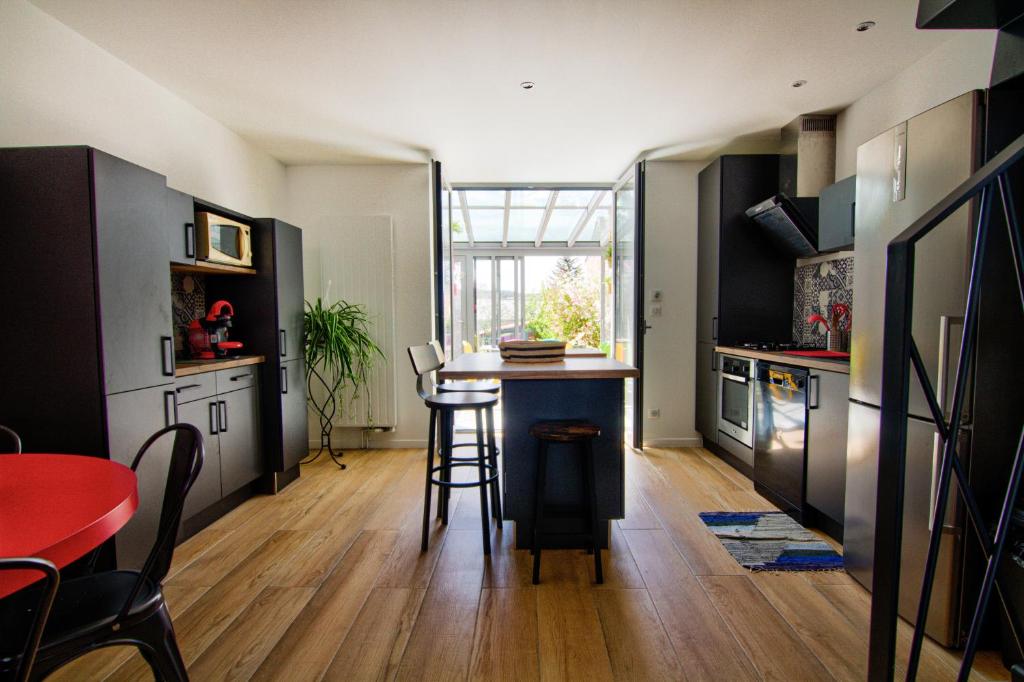 a kitchen with a island in the middle of a room at Le Pop in Saint-Julien-Chapteuil