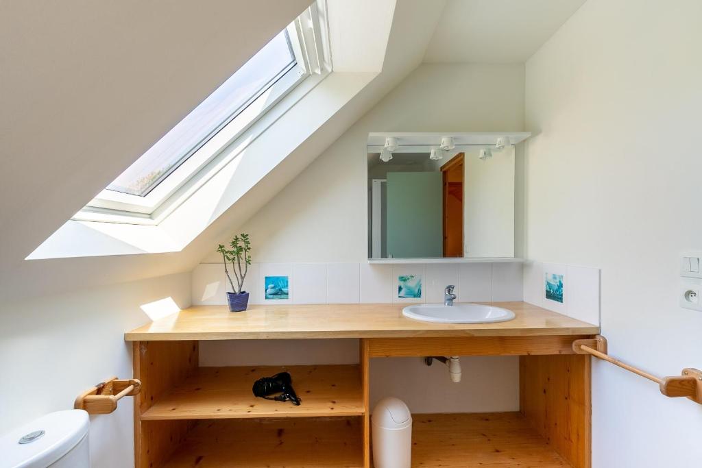 a bathroom with a sink and a skylight at Ty Lann in Telgruc-sur-Mer