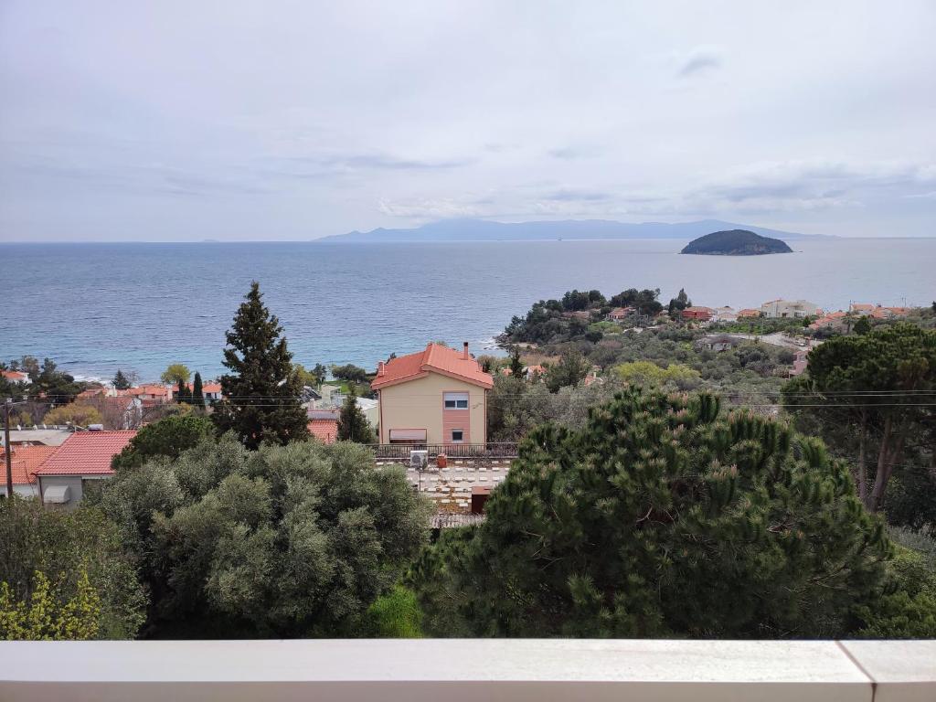 a view of a town with the ocean in the background at THEA COURT Clio & Erato Apartments in Paleo Tsifliki