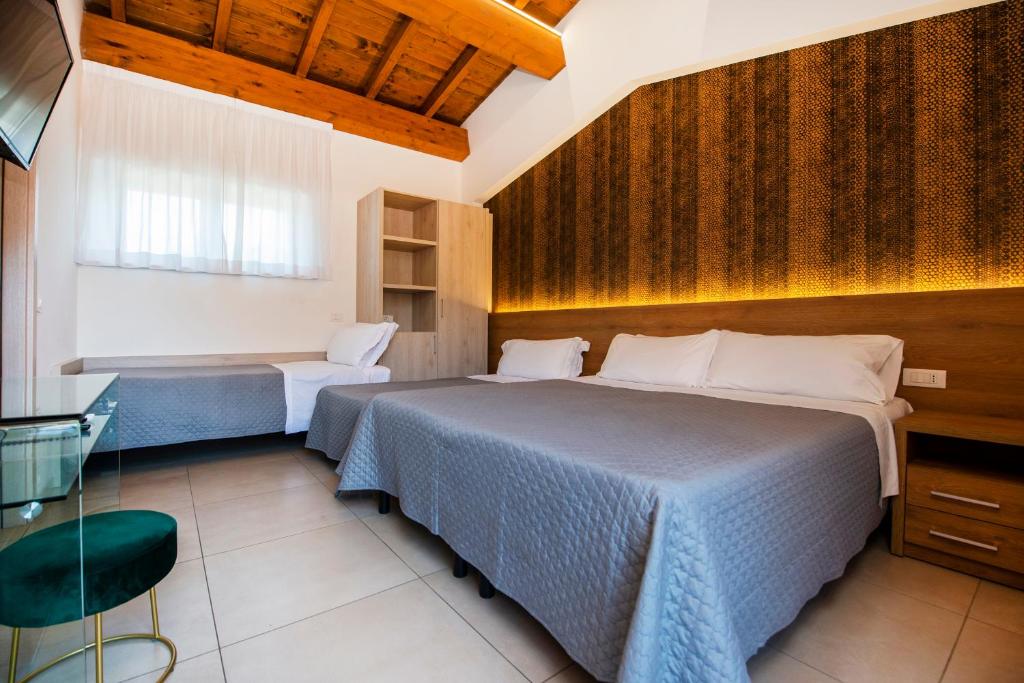 a bedroom with a bed and a table and a chair at Gu Hotel in Guidonia