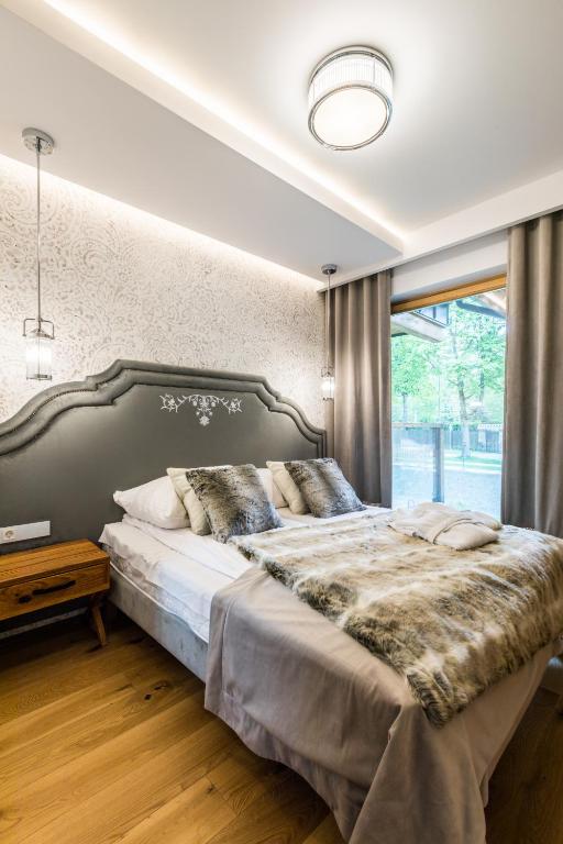 Posteľ alebo postele v izbe v ubytovaní Apartamenty Royal Resort Spa