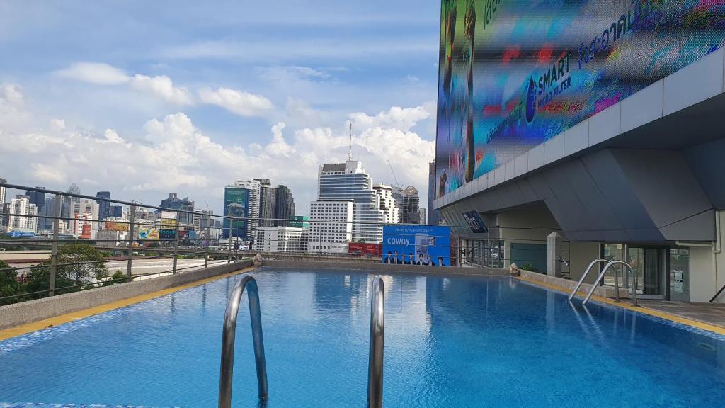 a large swimming pool on the side of a building at Interchange Tower Serviced Apartment - SHA Extra Plus in Bangkok