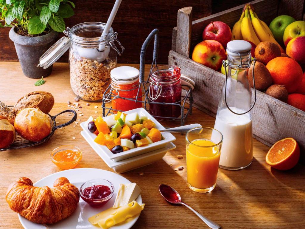 a table with fruits and other foods on it at ibis München Parkstadt Schwabing in Munich