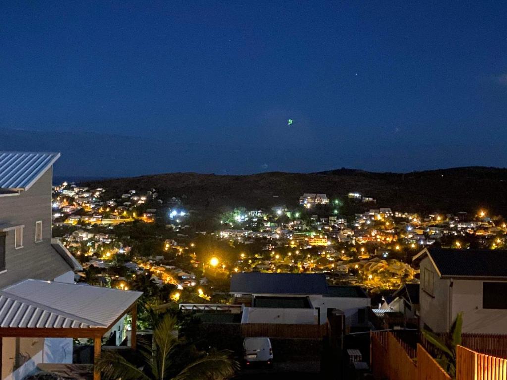 - une vue sur la ville la nuit avec des lumières dans l'établissement L'Été sans fin, vue montagne, à Filaos