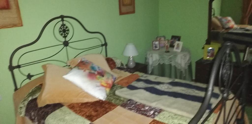 a bedroom with a bed with a quilt on it at Casa Herbellas in Cedeira