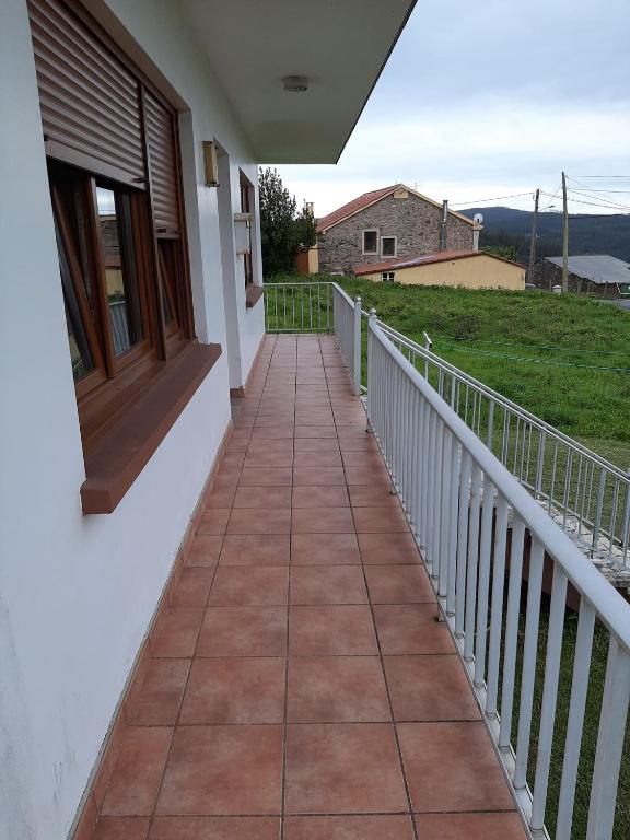 a walkway leading to a balcony with a door at Casa Herbellas in Cedeira