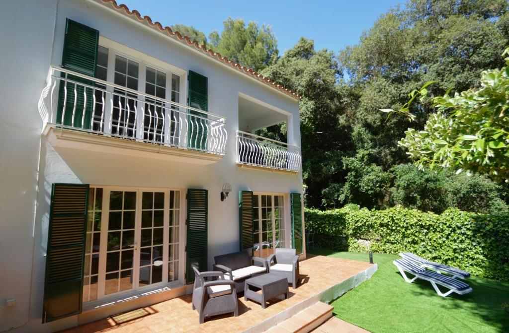 an exterior view of a house with a patio at Casa Playa by Sonne Villas in Ferreries