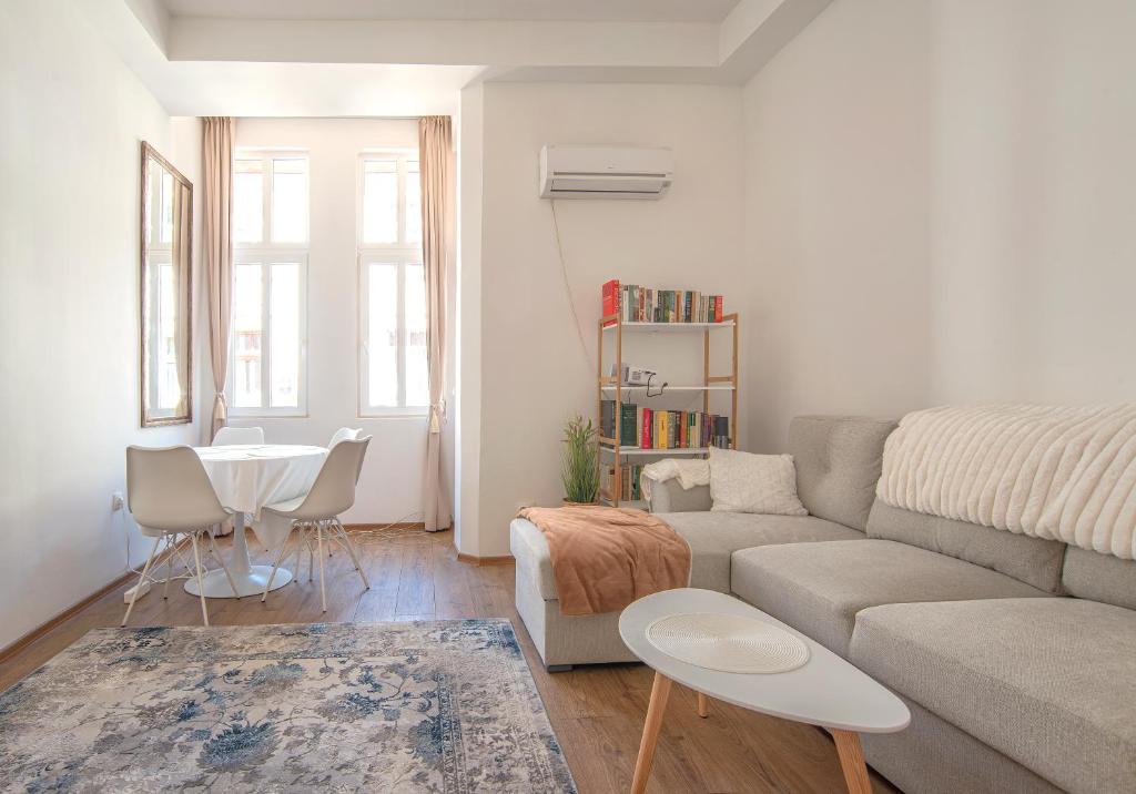 a living room with a couch and a table at Supreme Luxury Top Central 1 Bedroom Apartment in Sofia