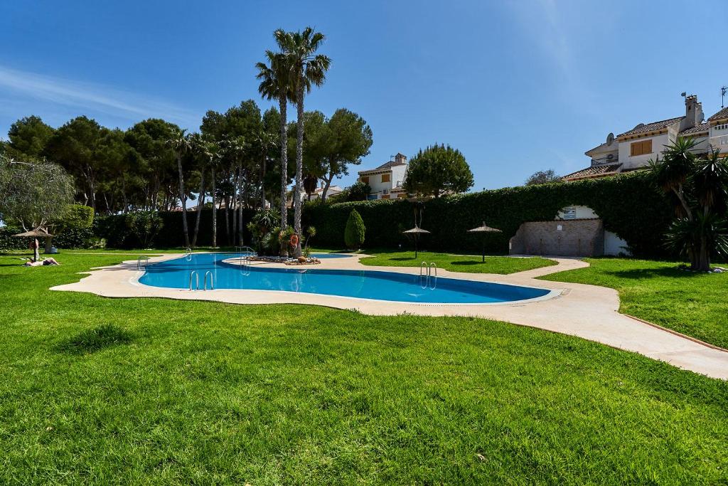 a swimming pool in the middle of a yard at Espanhouse Rio Mar in Pilar de la Horadada
