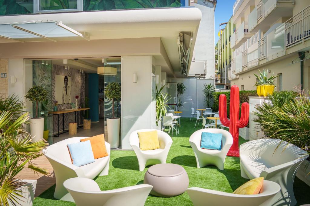 an outdoor patio with chairs and cactus at Design Hotel Astra B&B in Misano Adriatico