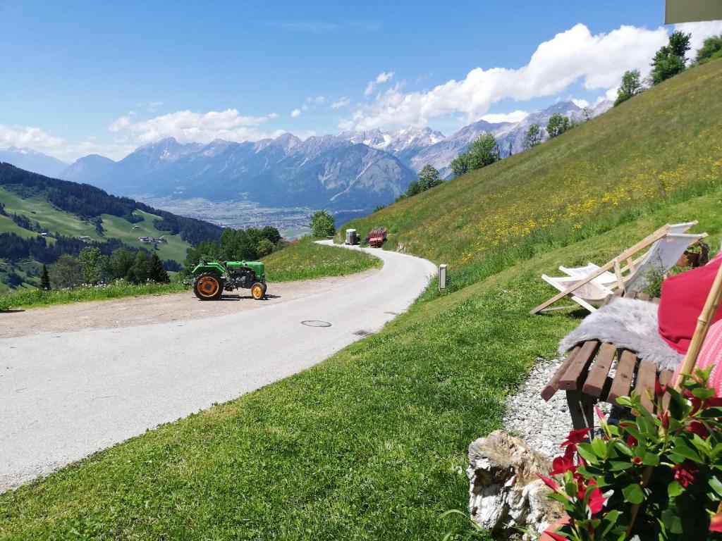 a green car driving down a road in the mountains at Much`s Bergstüberl in Wattenberg