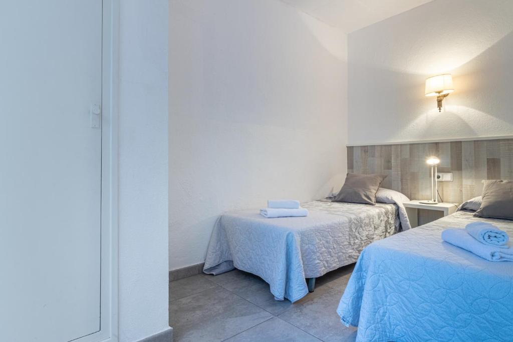 Posteľ alebo postele v izbe v ubytovaní Apartaments Falcó