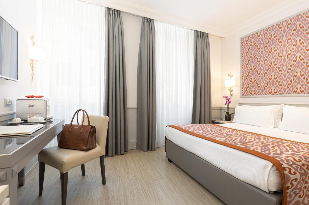 Postel nebo postele na pokoji v ubytování Hotel Della Conciliazione