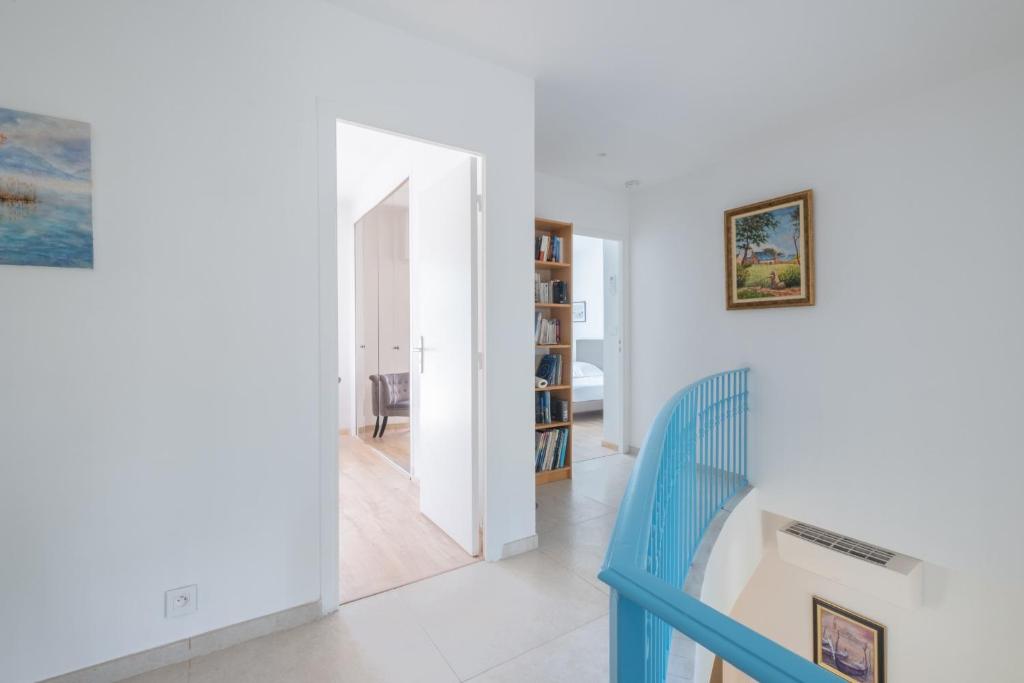a hallway with a blue staircase in a house at SERRENDY Calm family house with swimming pool in Antibes