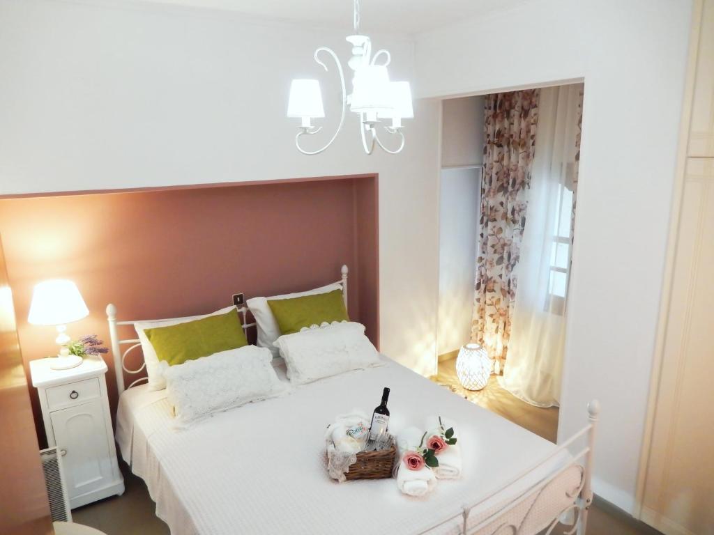 una camera con letto bianco e lampadario pendente di Portico Cozy Home a Kariá