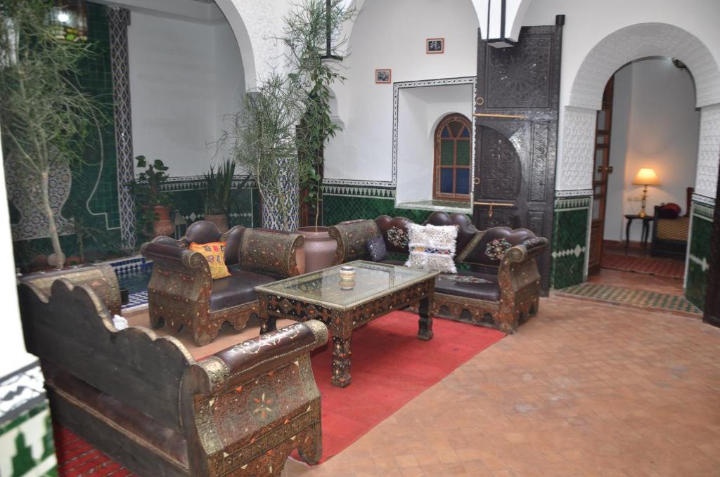 a living room with couches and a coffee table at Riad Assalam in Marrakech