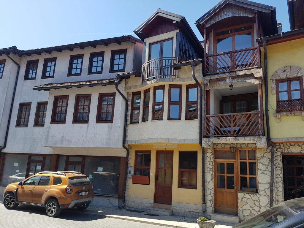 a yellow suv parked in front of a building at Old Town in Konjic