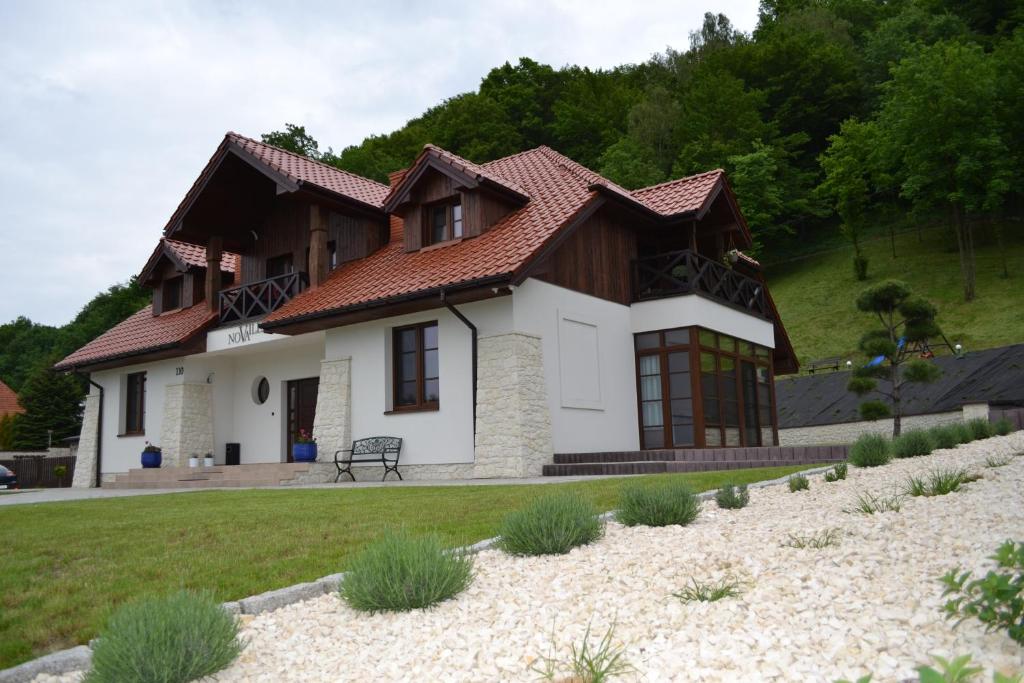 a white house with a brown roof at Villa Nova in Kazimierz Dolny