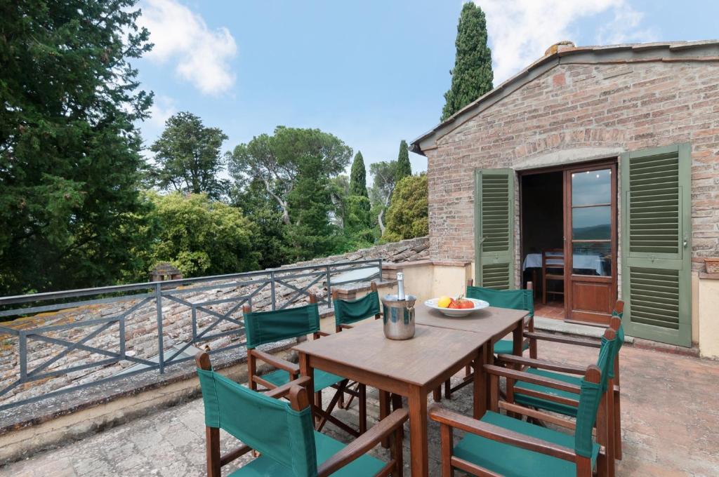 a patio with a table and chairs on a balcony at Fattoria la Gigliola - La Torre in Montespertoli