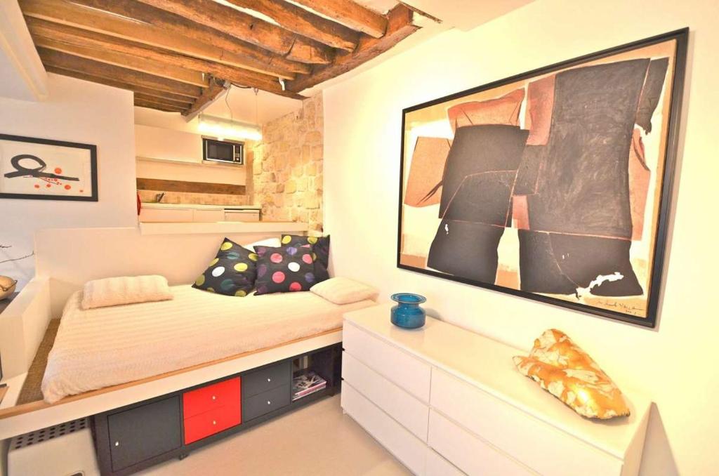 a bedroom with a bed and a large picture on the wall at Gallery in Paris