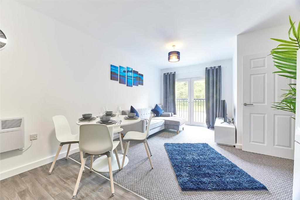 a white living room with a table and chairs at Low Lights - Properties Unique in North Shields