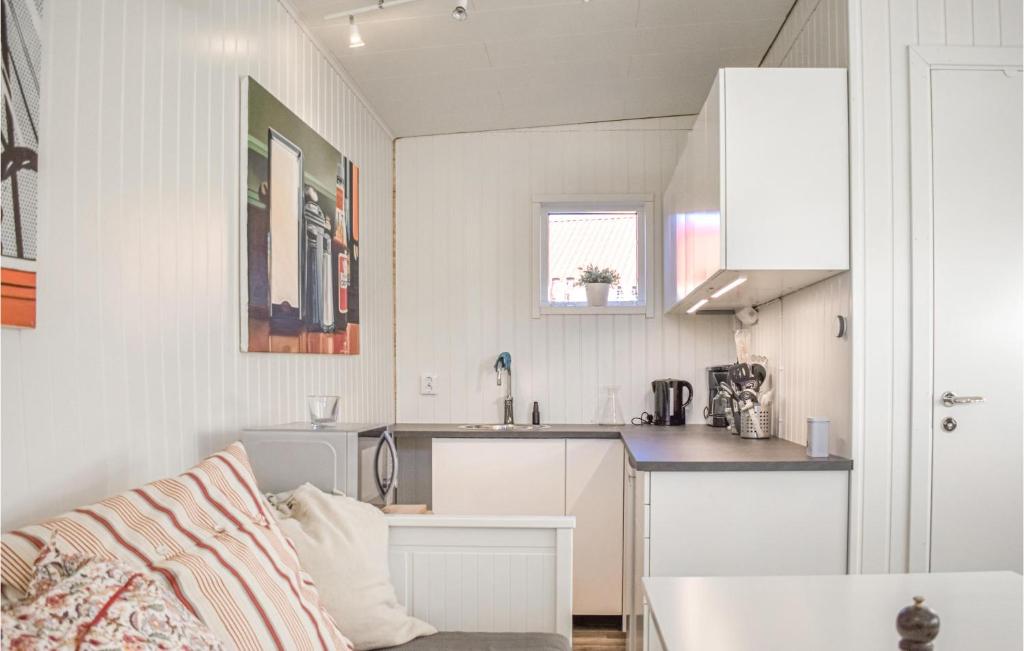 a white kitchen with a sink and a counter at Stunning Apartment In Sölvesborg in Sölvesborg