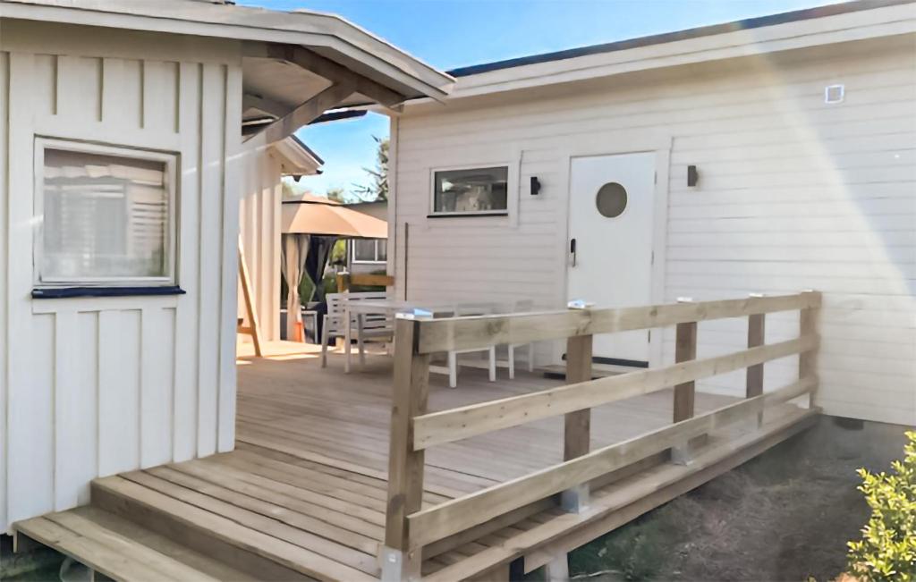 a wooden deck next to a house at Stunning Apartment In Sölvesborg in Sölvesborg