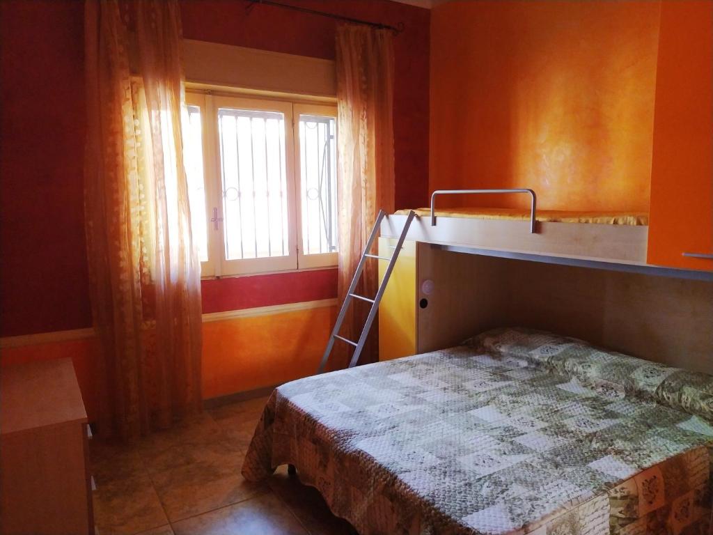 a bedroom with a bunk bed and a window at Casa Vacanze da Antonio in Torre Lapillo
