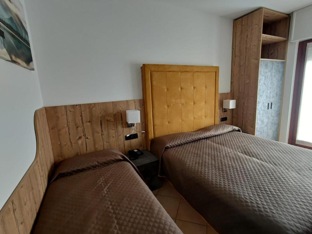 Postel nebo postele na pokoji v ubytování Albergo Casa Este