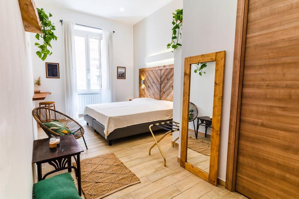 a bedroom with a bed and a large mirror at Adventor Eco-Suites in Rome