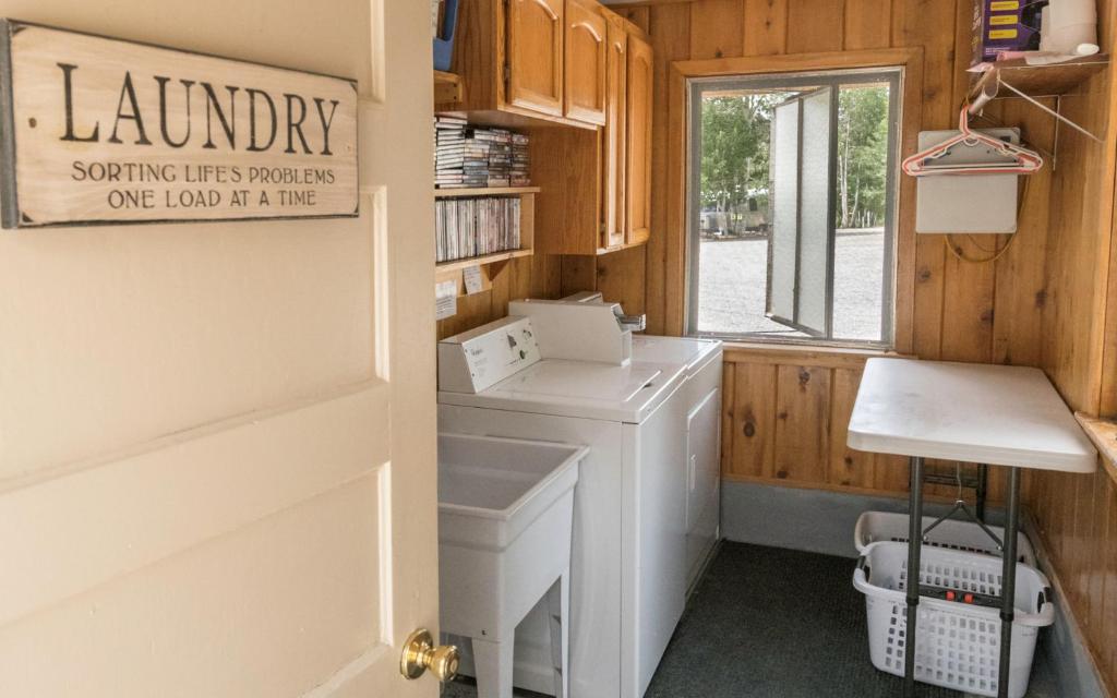 a laundry room with a washing machine and a window at Willow Springs Resort in Bridgeport