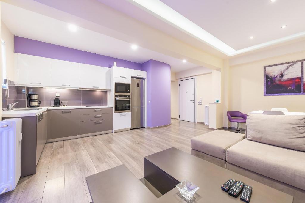 a large living room with a couch and a kitchen at An Impressive 2 bdr Apt in Glyfada in Athens