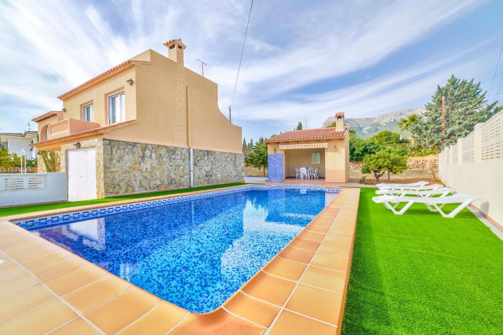 a villa with a swimming pool and a house at Villa Benicolada - PlusHolidays in Calpe