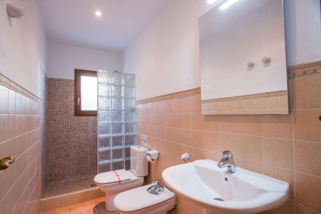 a bathroom with a sink and a toilet at Villa Altamira - Plusholidays in Calpe