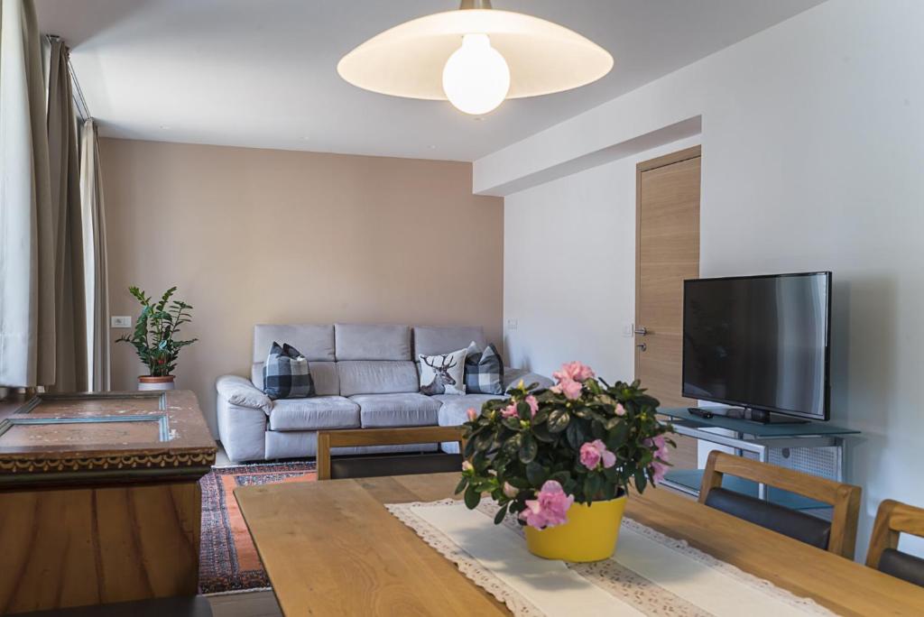 a living room with a couch and a table at Apartments Jalve in Ortisei