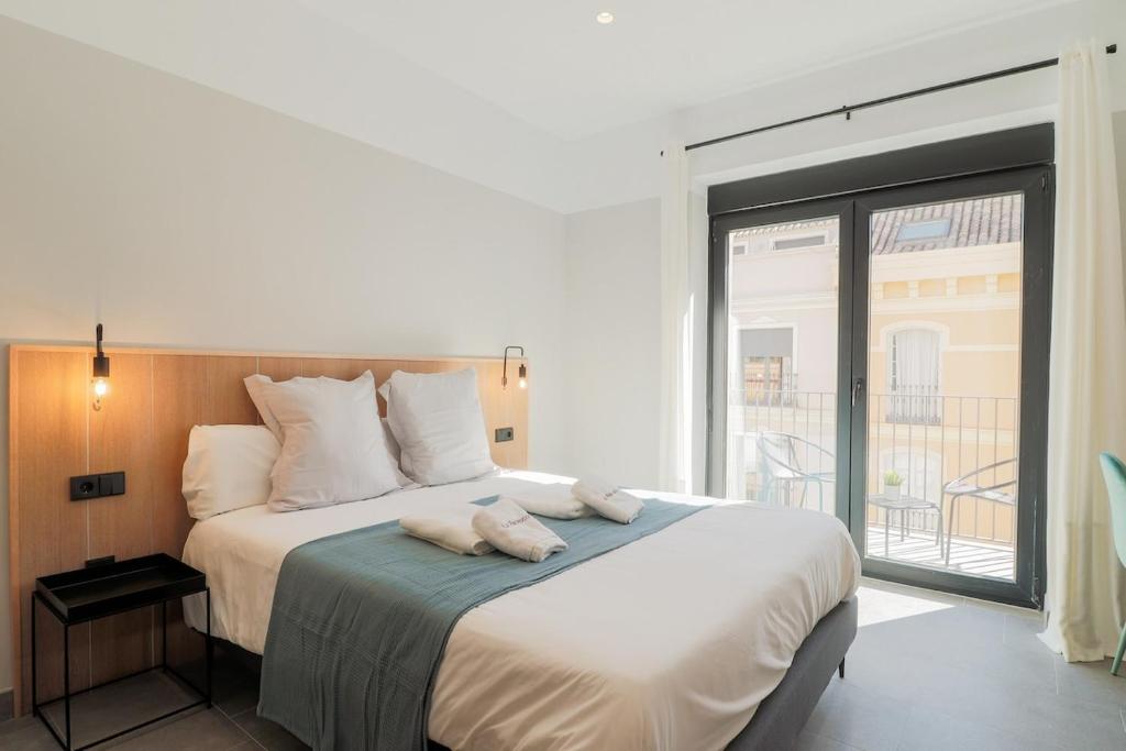 Posteľ alebo postele v izbe v ubytovaní Victoria Suites 57