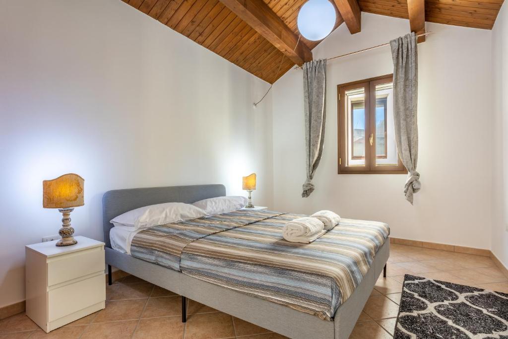 a bedroom with a bed and a window at ConVivo Apartment in Lecce